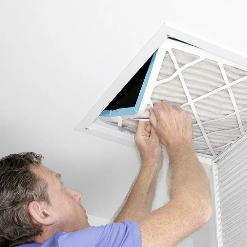 Black mold spots along the sealant and frame of a white plastic window, indicating moisture and condensation issues.